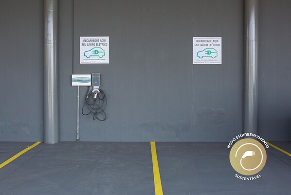 An empty electric vehicle charging station with two signs indicating where to park electric cars.