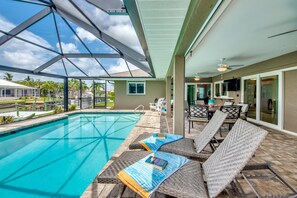 A pool area with lounge chairs and a covered patio. - Great for Sunbathing & Sunsets, 34 reviews (Cape Coral)