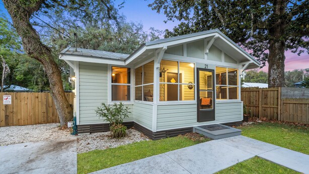 A small, single-story house with a porch, a front door, and a window. - Quiet get away in a vibrant city. (St. Augustine)