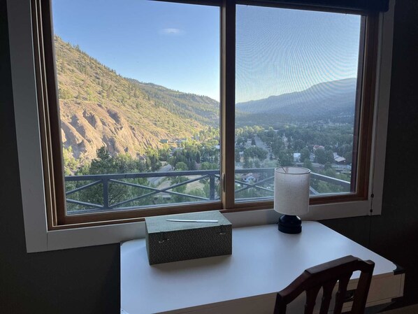 A room with a large window offering a view of a mountainous landscape and a town below. - Tower House - Views in all directions! Newly Remodeled (Lake City)