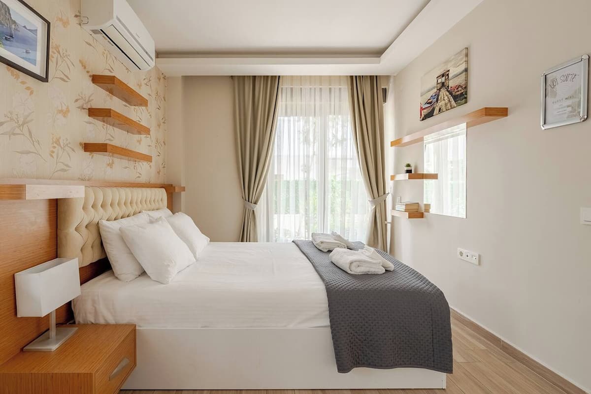 Premium bedding, desk, laptop workspace, blackout drapes