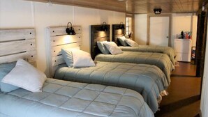 A room with three beds, wooden headboards, and a white wardrobe. - Waterfront 5 Bedroom (Karnack)