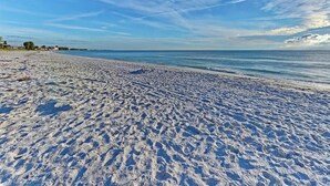 A beach with a clear sky and calm sea. - 1 Block to Beach | Golf Cart + Heated Pool (Holmes Beach)