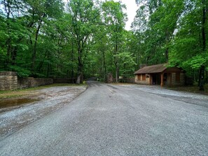 Escape to a secluded forest retreat with a traditional lodge featuring a cozy porch and a rustic charm.