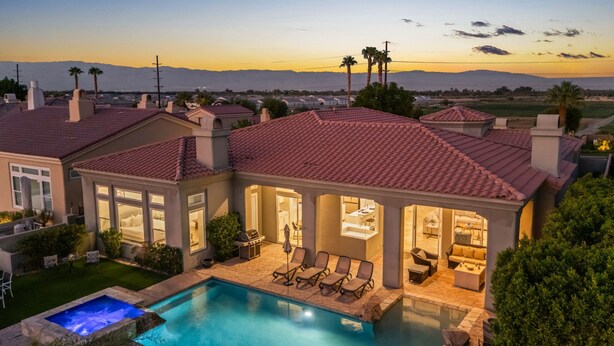 A luxurious house with a swimming pool, outdoor seating, and a view of the mountains. - Multi-Million Dollar PGA West 4BR/5BA Pool/Spa (La Quinta)
