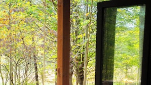 A room with a bed, a window, and a view of trees. - Rekindled @ The Patch, lux couples getaway, hot tub, outdoor living. (Laurelville)