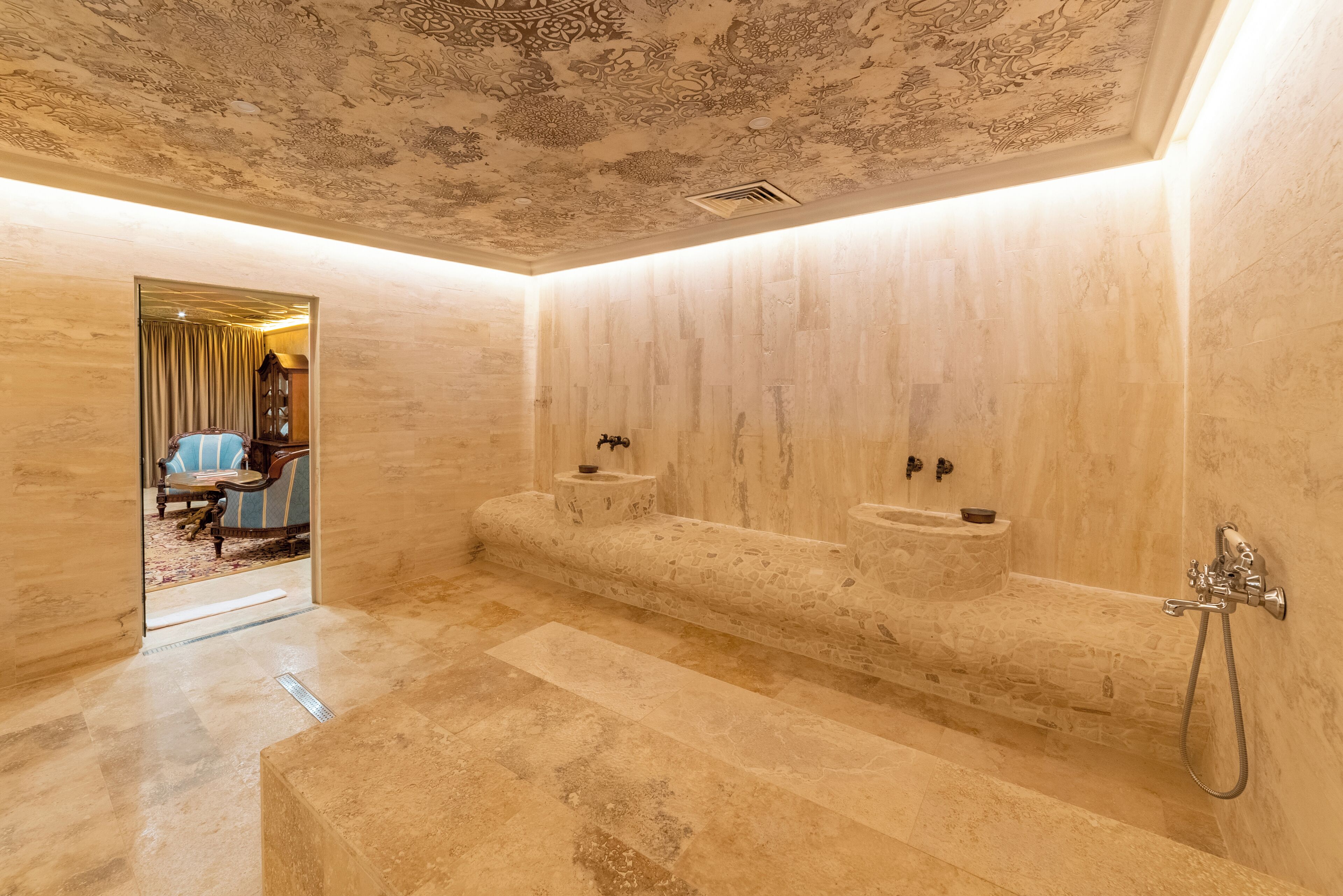 A spacious bathroom with a large bathtub, two sinks, and a decorative ceiling.