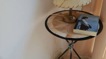 A small round table with a lamp and a book.