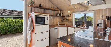 Fridge, stovetop, dishwasher, coffee/tea maker