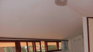 A bedroom with a large bed, a smaller bed, a nightstand, and a wardrobe. - Bright Villa With Garden and Parking - Beahost (San Michele al Tagliamento)