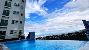 Outdoor pool, open 6:00 AM to 10:00 PM, pool umbrellas, pool loungers