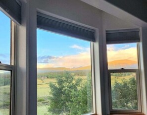 Enjoy a serene view of the surrounding countryside from the large windows in this room.