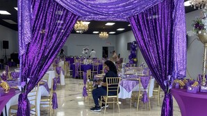 A banquet hall with tables set for a formal event, featuring purple drapery and gold chairs. - Amazing Event Space with Ample Parking  (Marietta)