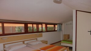 A bedroom with a bed, nightstands, a dresser, and a window with curtains. - Wonderful Villa With Private Garden - Beahost (San Michele al Tagliamento)
