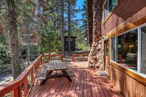 Enjoy outdoor dining or relaxation on the deck with a picnic table and benches.