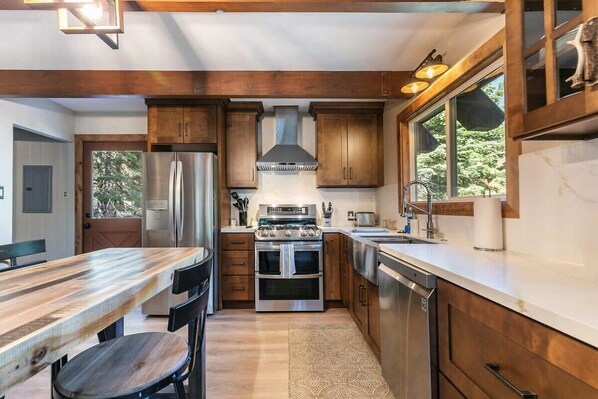 Enjoy cooking in this well-equipped kitchen with a central island, oven, and dishwasher.