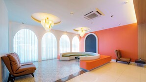 A modern lobby with a reception desk, seating area, and large windows. - M CASA HOTEL PATTAYA (Pattaya)