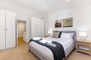 A bedroom with a bed, two nightstands, a wardrobe, and two framed pictures on the wall. - Hatton Ville Fireplace/Village 5 Minutes/Gardens (Leura)