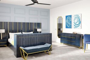 Een moderne slaapkamer met een bed, nachtkastjes, een bankje, een dressoir en kunst aan de muur.