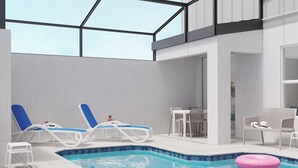 Area piscina interna moderna con due poltrone relax, un tavolino e un bracciale rosa.