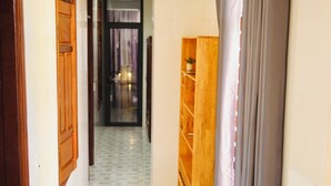 A hallway with wooden cabinets and a tiled floor. - The Dorm Tam Toà (Dong Hoi)