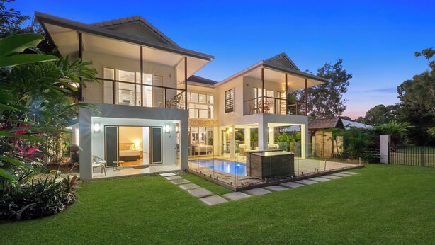 A modern two-story house with a swimming pool, a covered patio, and a well-maintained lawn. - This stunning home is located in Palm Cove. Short 5min walk to the beach. (Palm Cove)