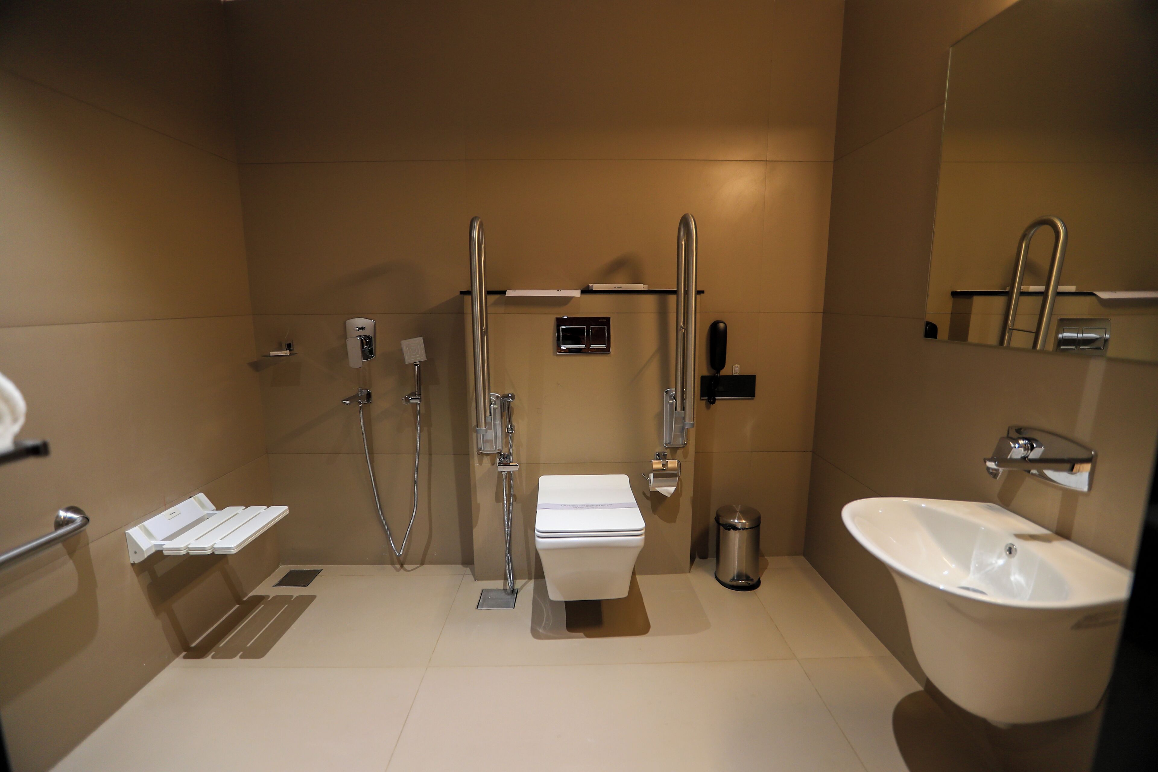 A modern bathroom with a toilet, bidet, and sink.