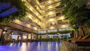 A multi-level indoor pool area with a bar and seating area. - DACO Hotel (Siem Reap)