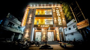 A hotel with a modern facade, illuminated signage, and a well-lit entrance. - Hotel Amber  (Thanesar)