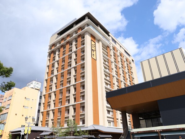 A high-rise hotel with multiple floors, balconies, and a modern architectural design.