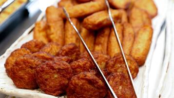 A plate of fried food items, including skewered and cylindrical shapes, likely a variety of snacks or appetizers.