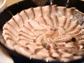 A close-up of sliced fish arranged in a circular pattern on a pan. - Beppu Hattou Onyado Nono Beppu (Beppu)
