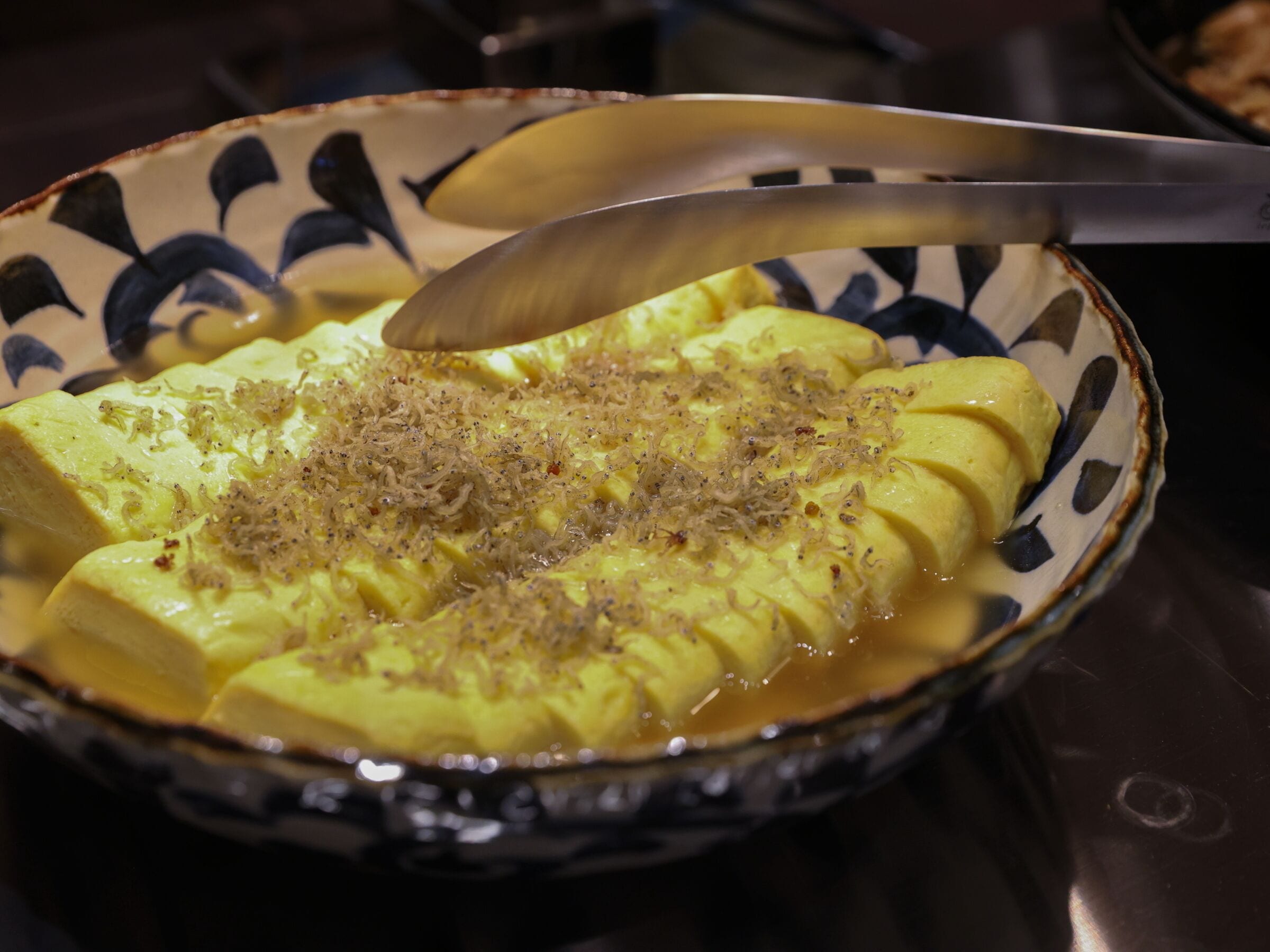A bowl of food with a spoon.