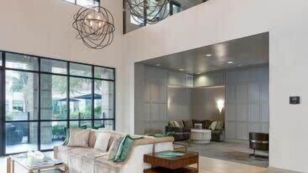 A spacious living area with a high ceiling, large windows, and modern furniture. - Rose at the Millennium - Stylish 1 BR in Houston (Houston)