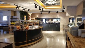 A modern kitchen with a central island, wooden furniture, and a variety of kitchen appliances. - Gardan Hotel (Istanbul)