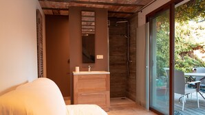A modern bathroom with a wooden vanity, a large mirror, and a glass shower enclosure. - La Villa des Gones (Dommartin)