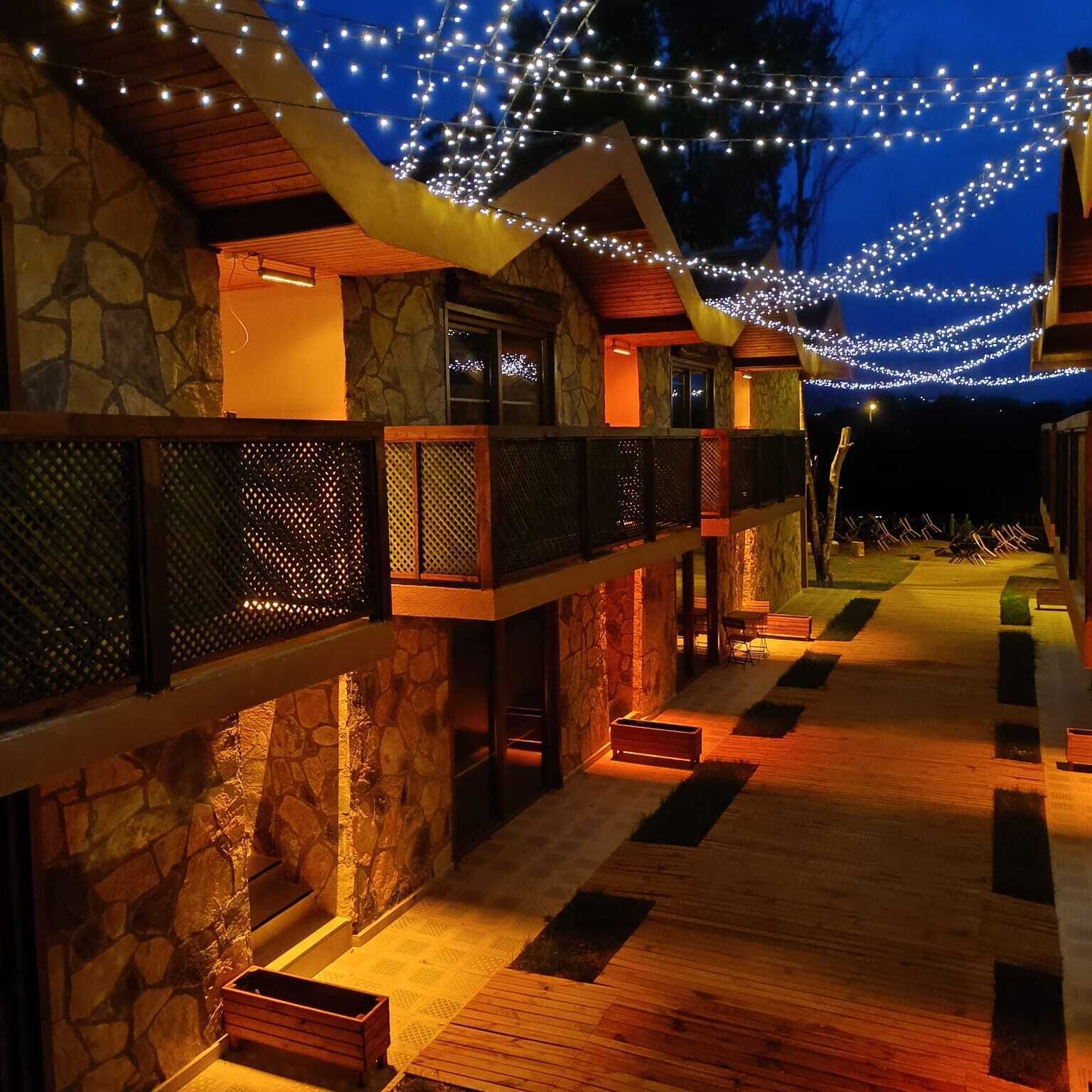 A building with stone walls, wooden floors, and a covered walkway.