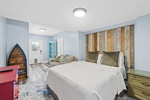 A bedroom with a bed, dresser, and a shoe rack.