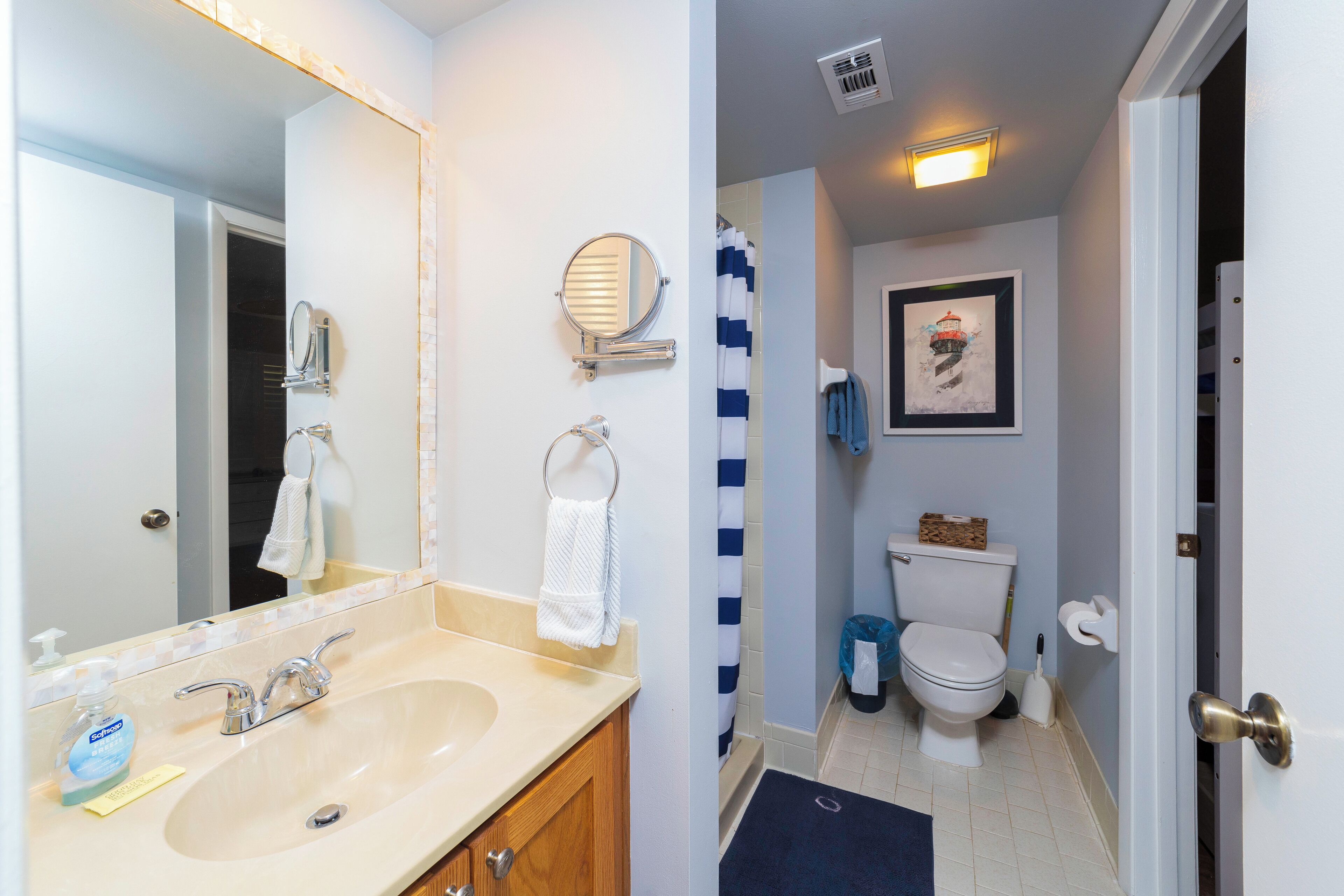 A bathroom with a sink, mirror, towel rack, and toilet.