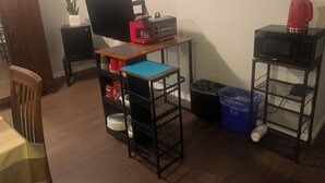A small room with a desk, a computer, a microwave, and a trash bin. - Cozy Luxury in peaceful Caledonia,  13 minutes away from Hamilton Airport  (Caledonia)