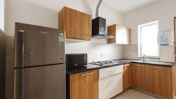 Fridge, microwave, cookware/dishes/utensils, dining tables