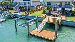 A waterfront property with multiple docks, a pool, and a large house with a balcony. - Dream On #145 - Private boat dock, short walk to the beach, dog friendly! (Topsail Beach)