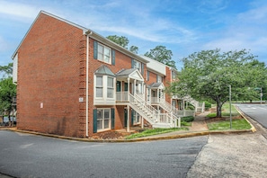 A two-story brick building with a front porch, a staircase, and a 'No Parking' sign. - Five Points Dawg Crib On Campus (Athens)