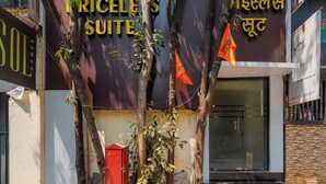 A hotel sign with "HOTEL RICELES SUITE" and another sign with "HOTEL" and a different language. - Hotel Priceless Suite (Mumbai)