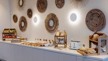 A breakfast buffet with various food items and decorative wall mirrors.