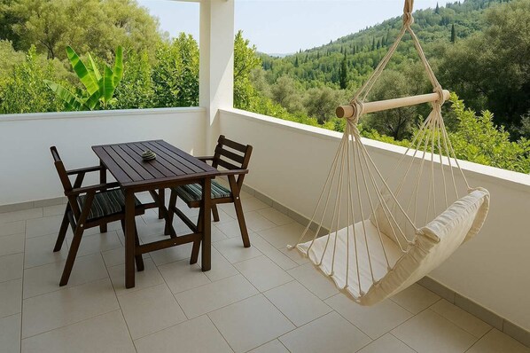 Enjoy a peaceful meal or social gathering on the balcony, overlooking a serene landscape.
