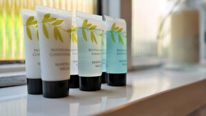 Four bottles of Nourishing Condition Shampoo and Nourishing Condition Shower on a shelf. - Stonelea (Tideswell)