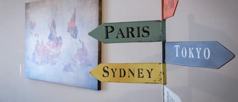 A wall with directional signs pointing to various cities.