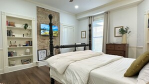 A bedroom with a four-poster bed, a bookshelf, a desk, and a window with curtains. - Bourbon Trio: Walkable to Restaurants, bars, shops and the Capitol building (Frankfort)