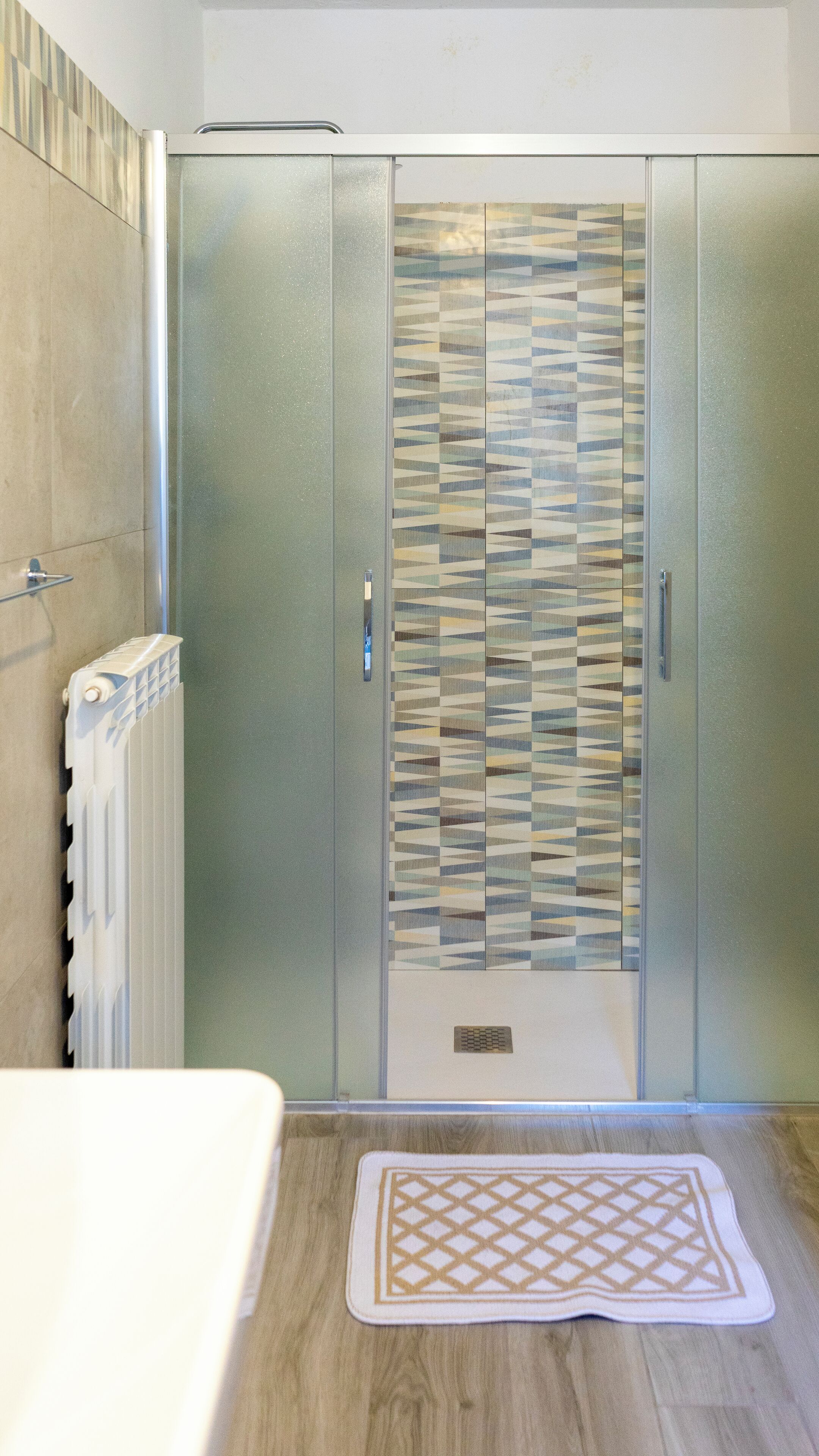 A bathroom with a shower, a toilet, and a sink.